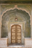 a large wooden door sitting inside of a building
