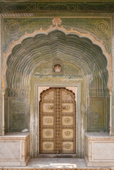 a large wooden door sitting inside of a building