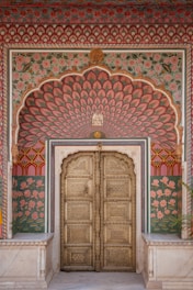 a large wooden door in a colorful building
