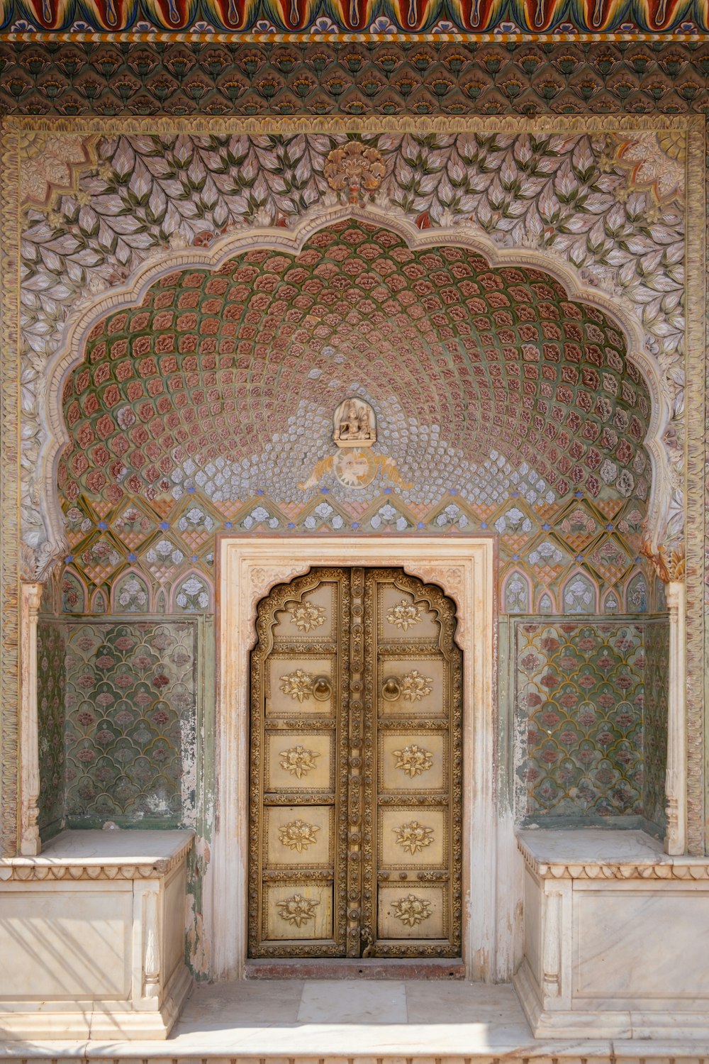 a large ornate doorway with a gold door