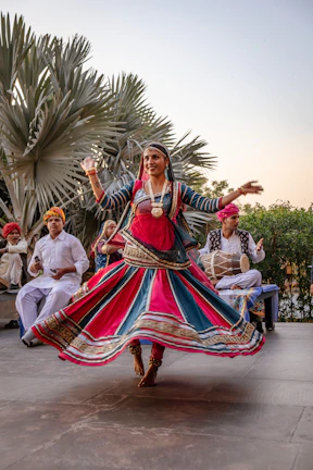a woman in a colorful dress dancing in front of a group of people