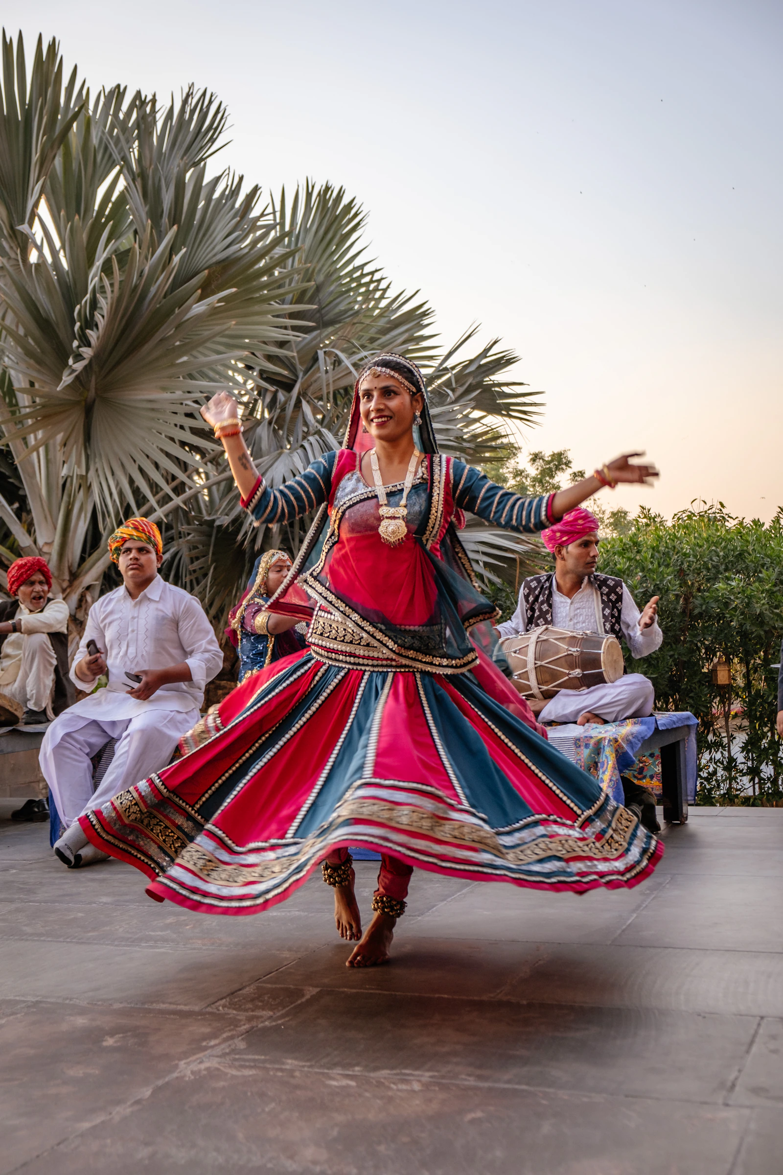 A dancer performing in front of guests at an Indian wedding celebration.