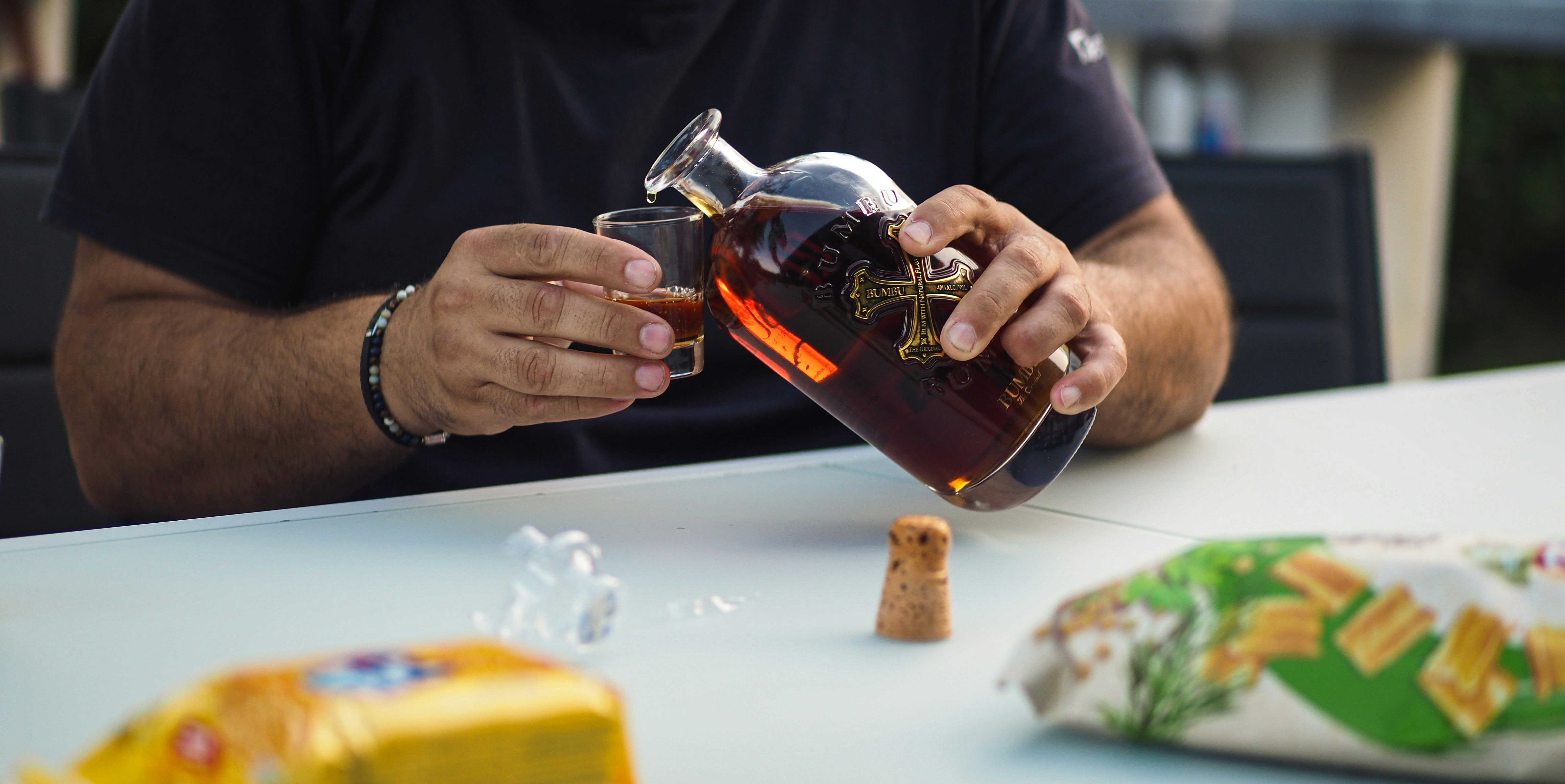 a man is pouring a drink into a glass