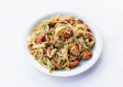 a plate of spaghetti with tomatoes and parsley