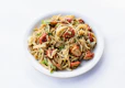 a plate of spaghetti with tomatoes and parsley