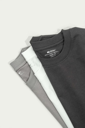 a pair of black and white shirts sitting on top of each other