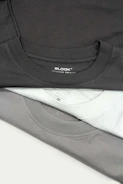 a pile of black and white shirts sitting on top of each other