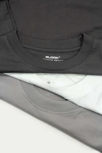 a pile of black and white shirts sitting on top of each other