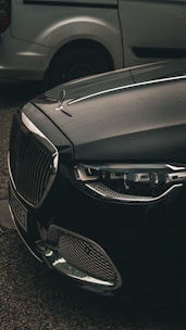 a black car parked next to a silver car