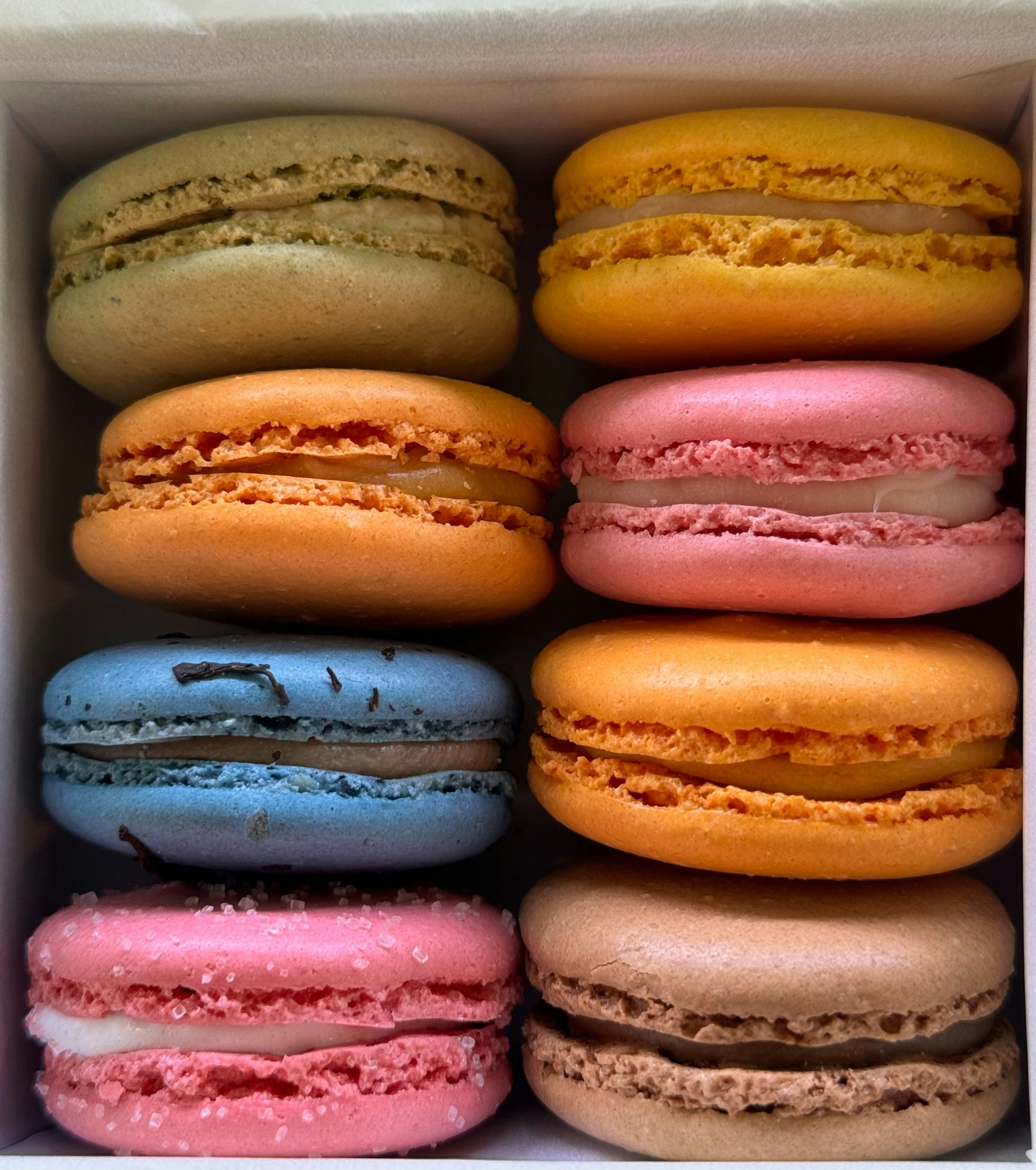 a box filled with lots of different colored macaroons