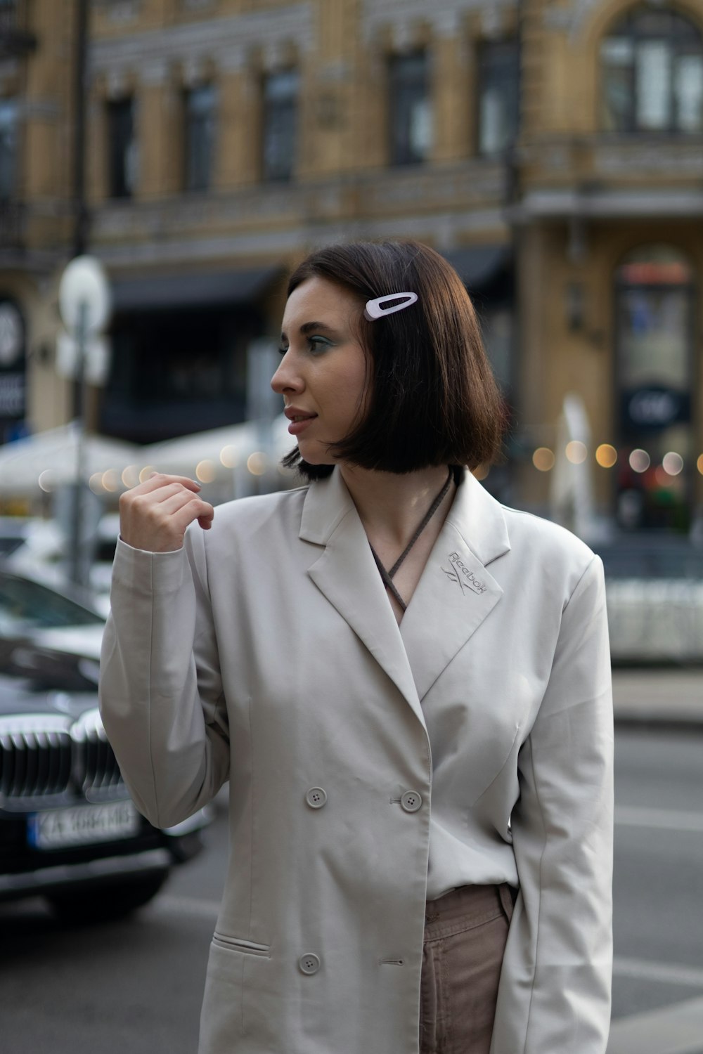  a woman in a business suit is standing on the street