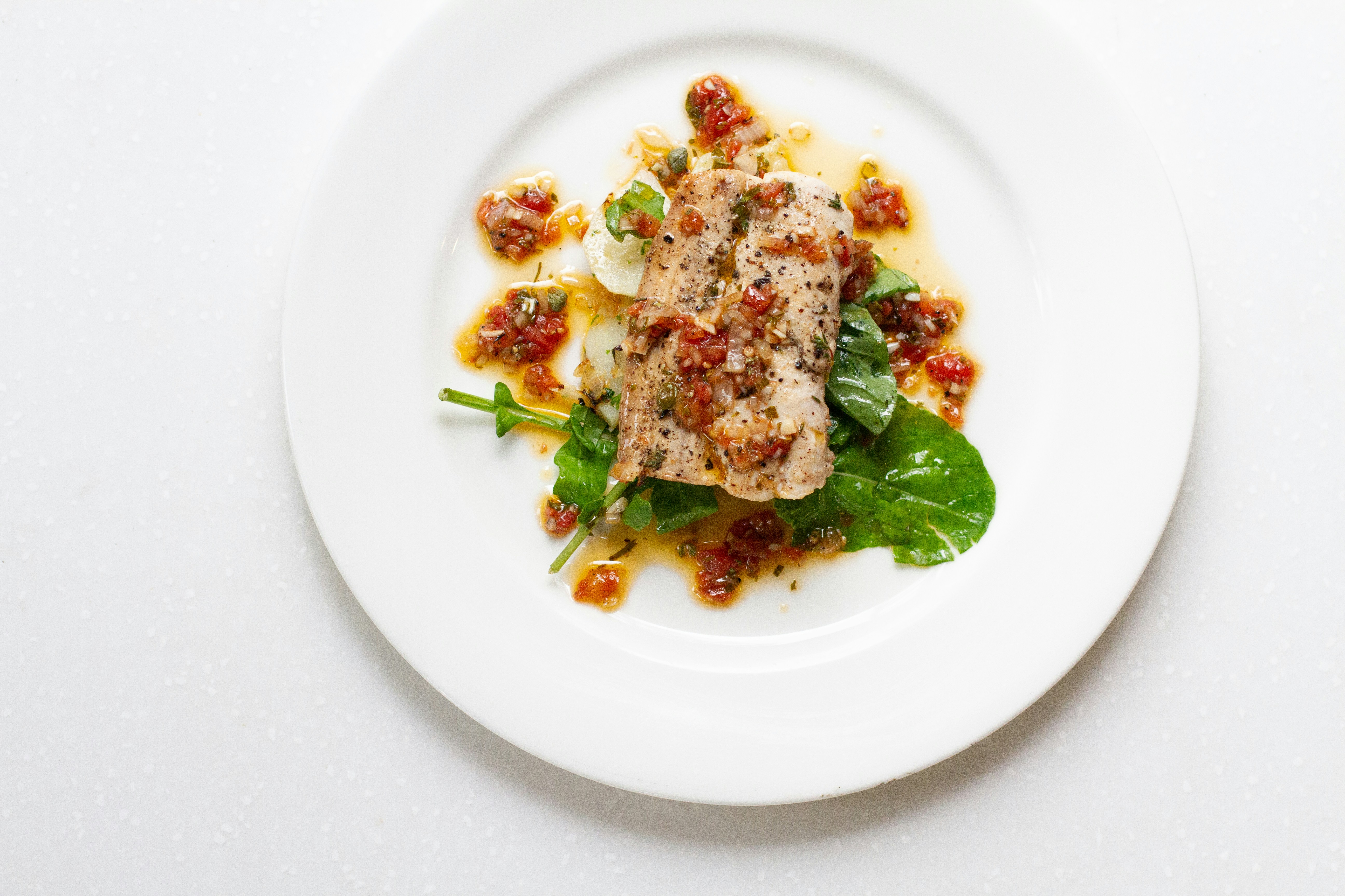 a white plate topped with meat and vegetables