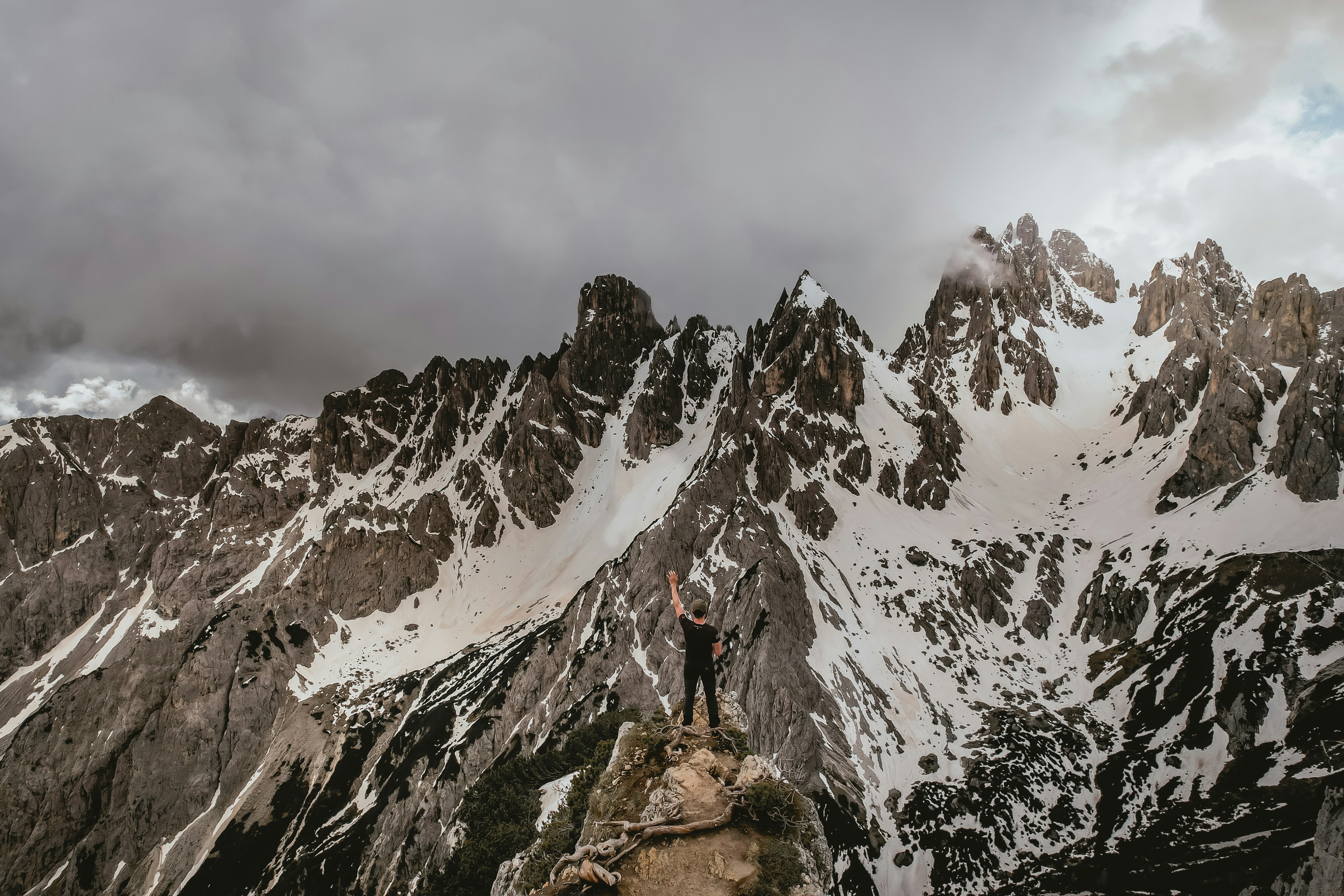a man standing on top of a snow covered mountain