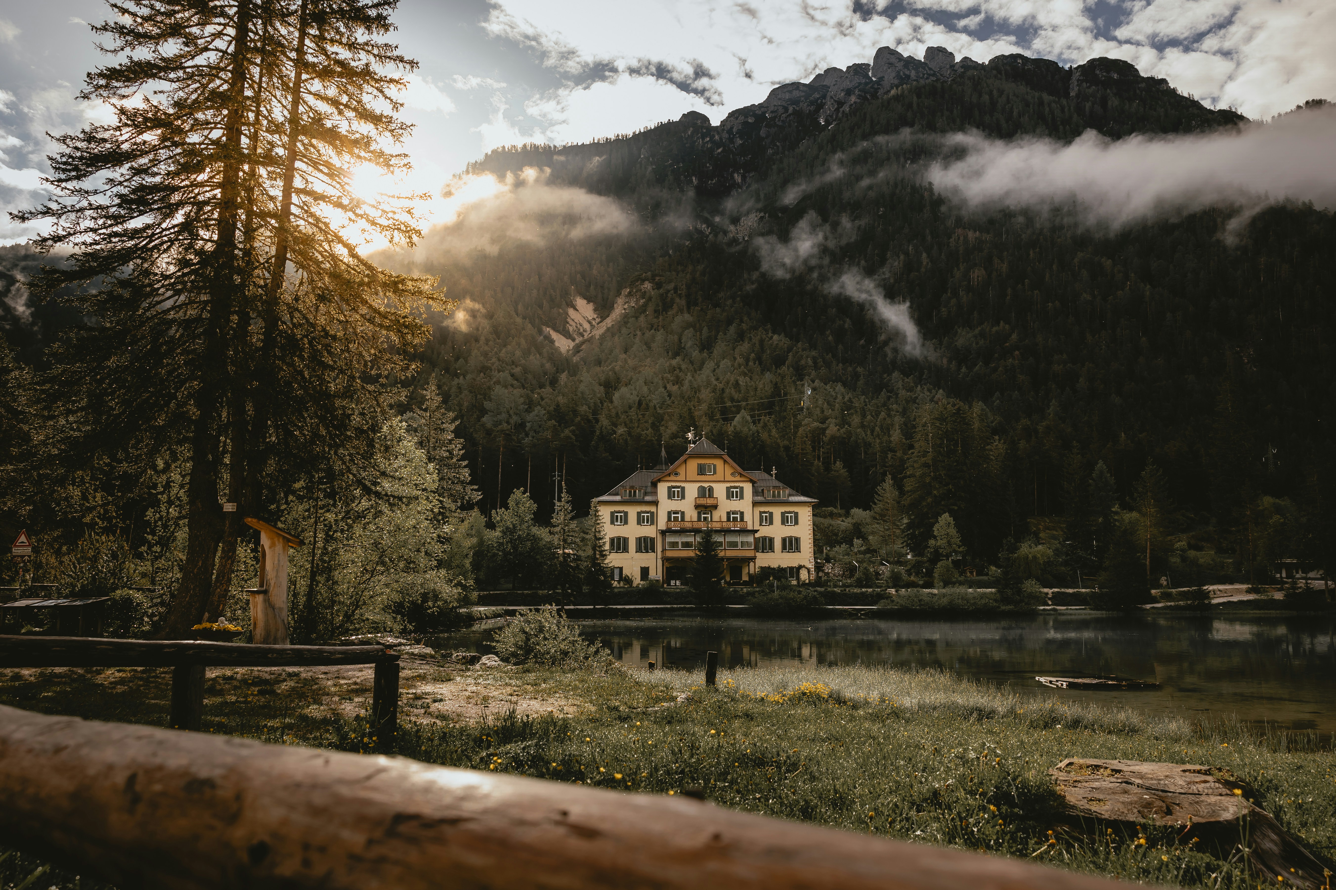 a large house sitting in the middle of a forest
