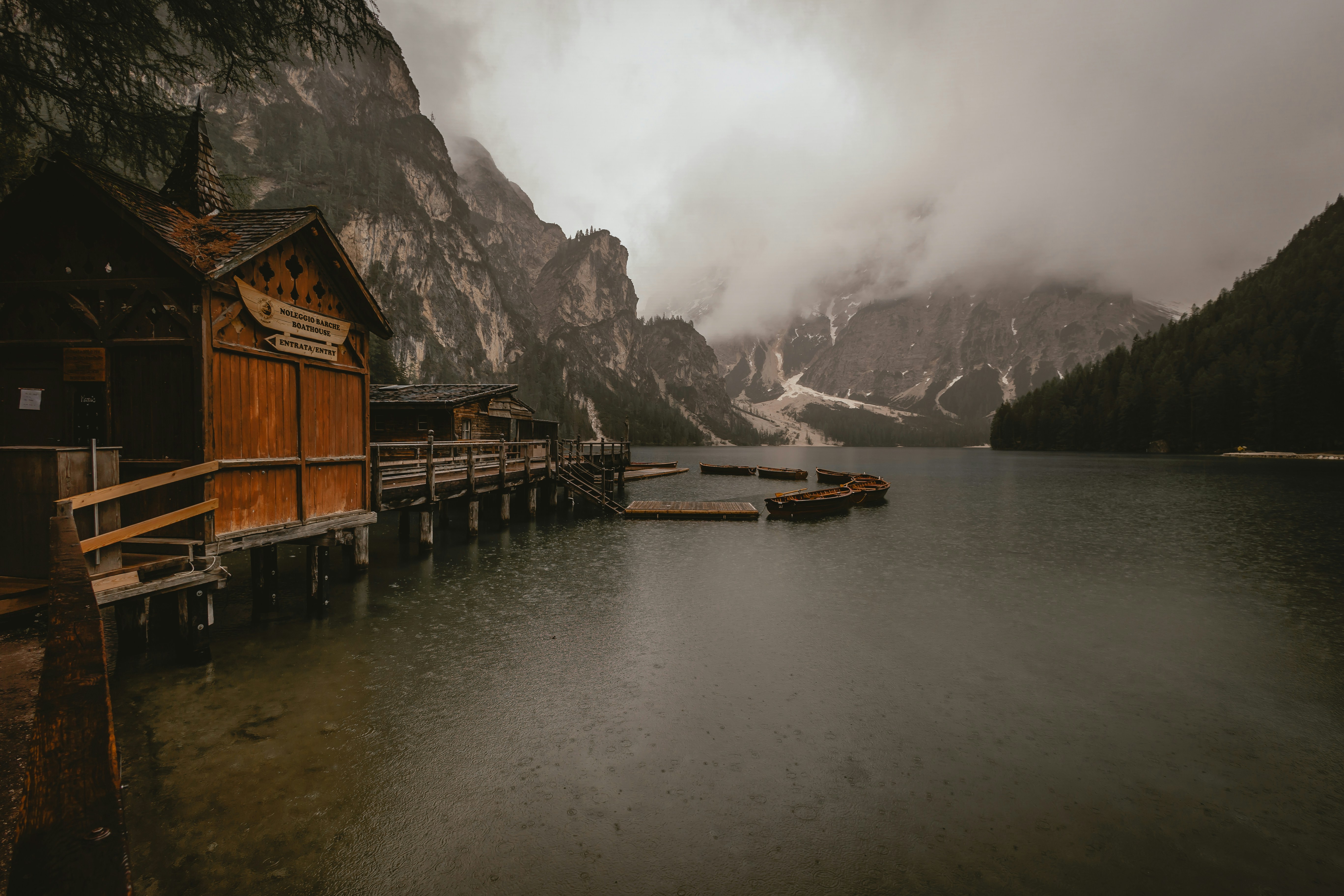 a boat dock on a lake with mountains in the background