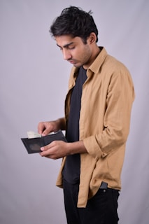 a man in a brown shirt and black pants
