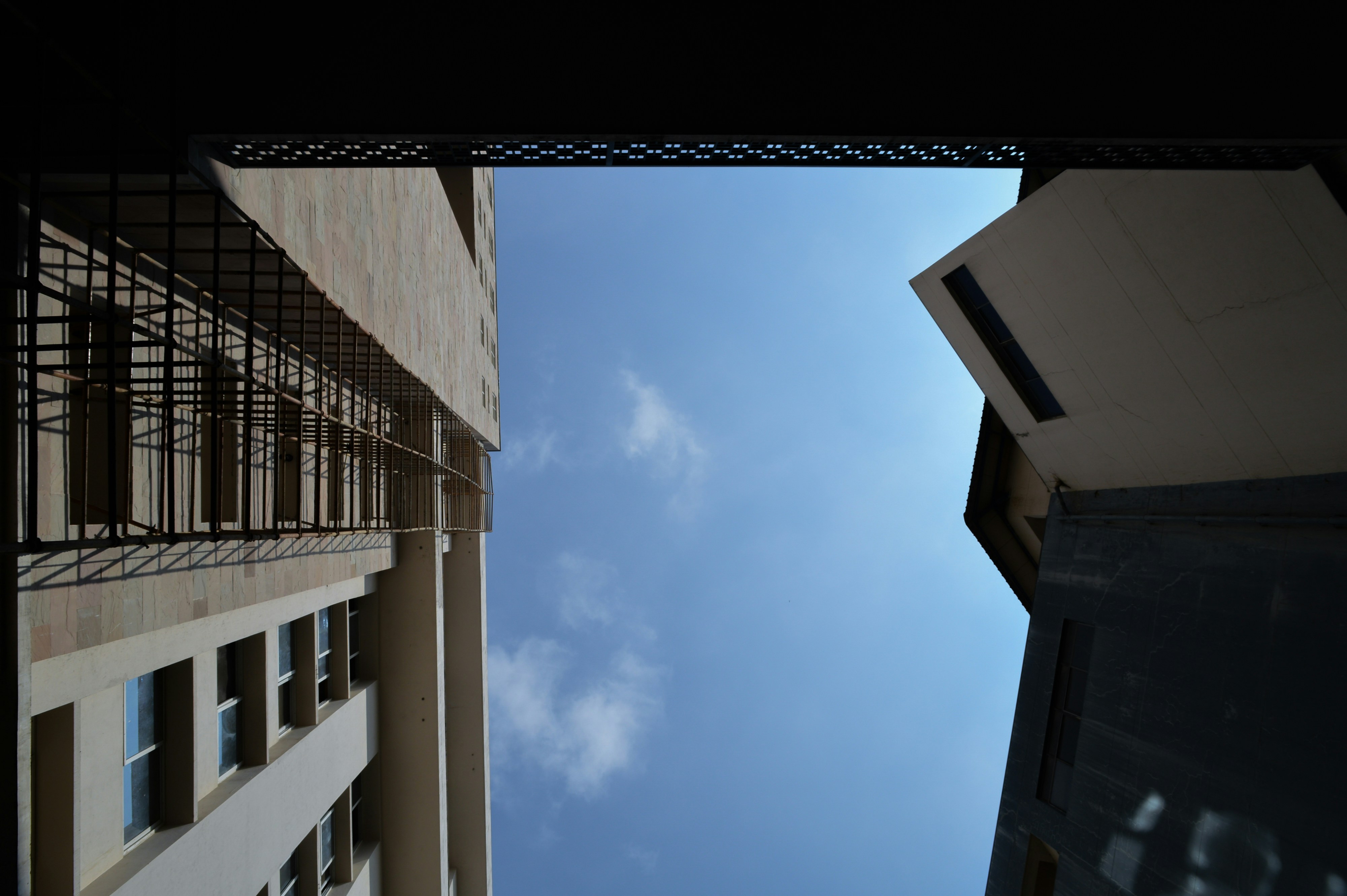 A view of a building from the ground looking up at the sky