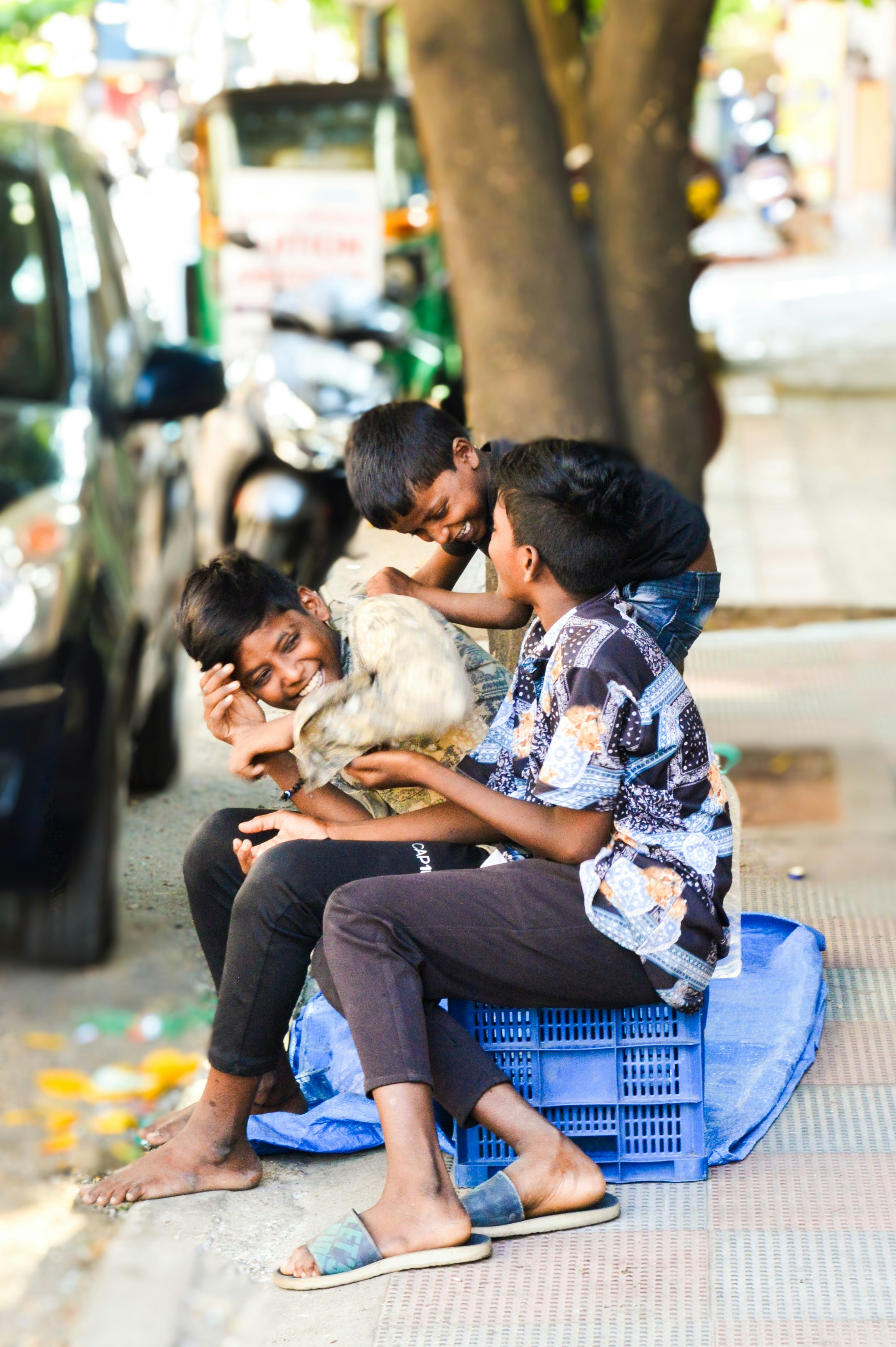 A group of people sitting on a blue bench