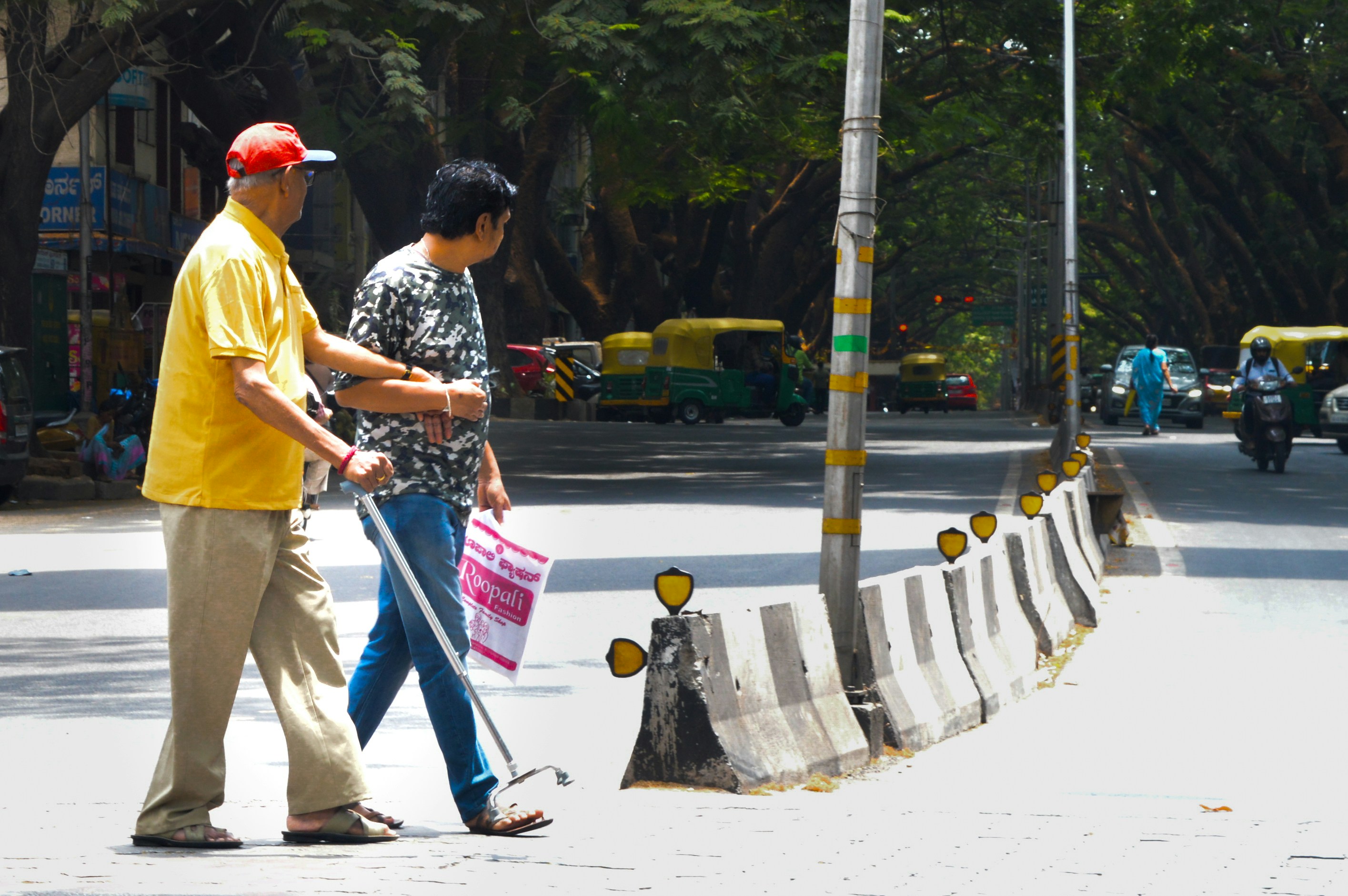 Two men walking down a street with a street sign