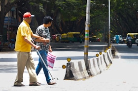 Two men walking down a street with a street sign