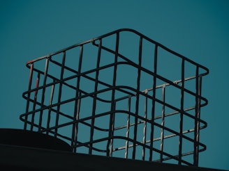 a metal basket sitting on top of a roof