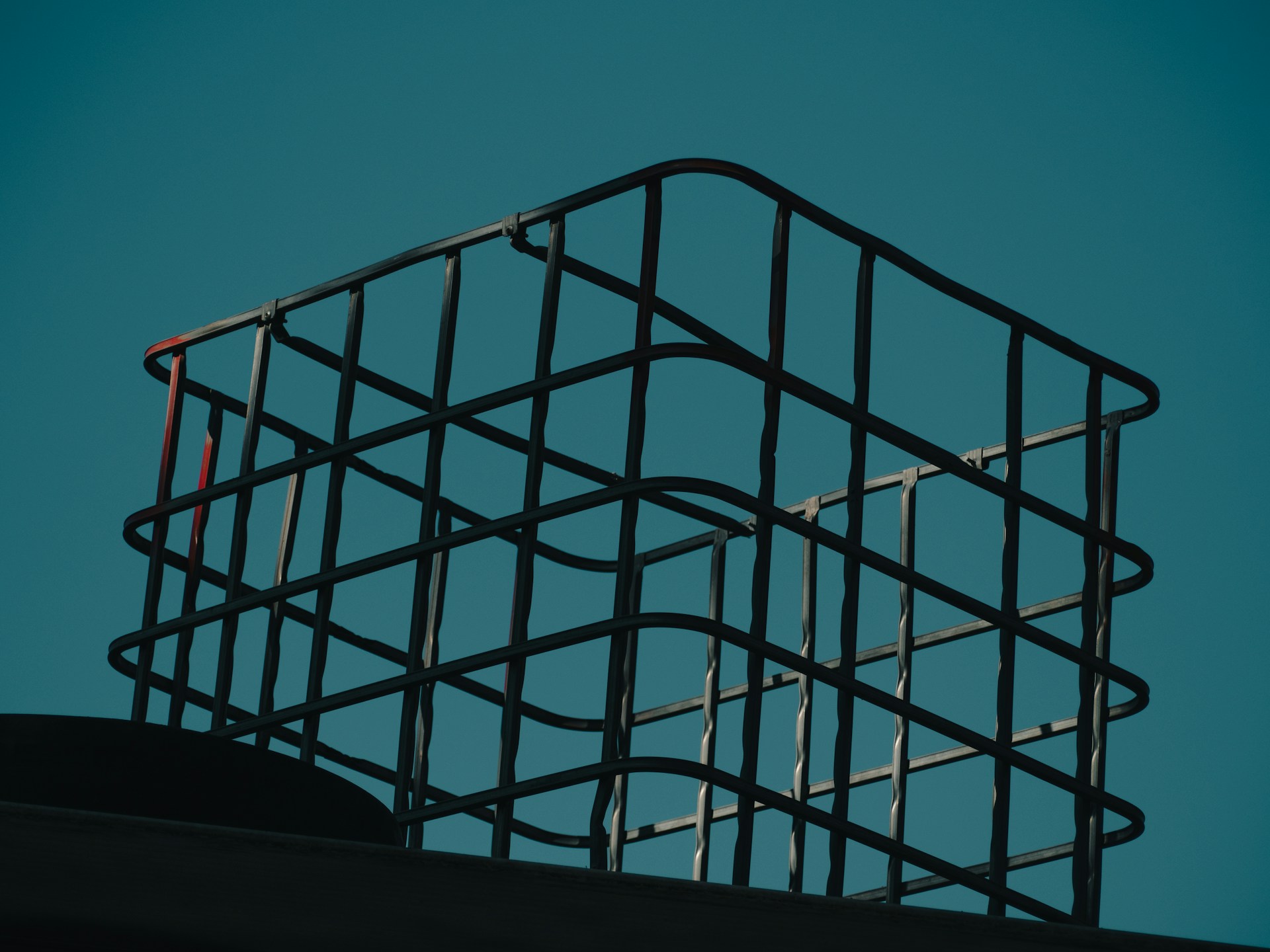 a metal basket sitting on top of a roof