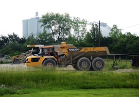 a dump truck is parked in a field