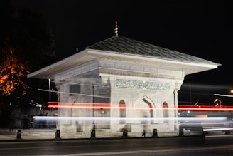 a large white building with a clock on it's side