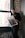 a man standing in front of a window reading a newspaper