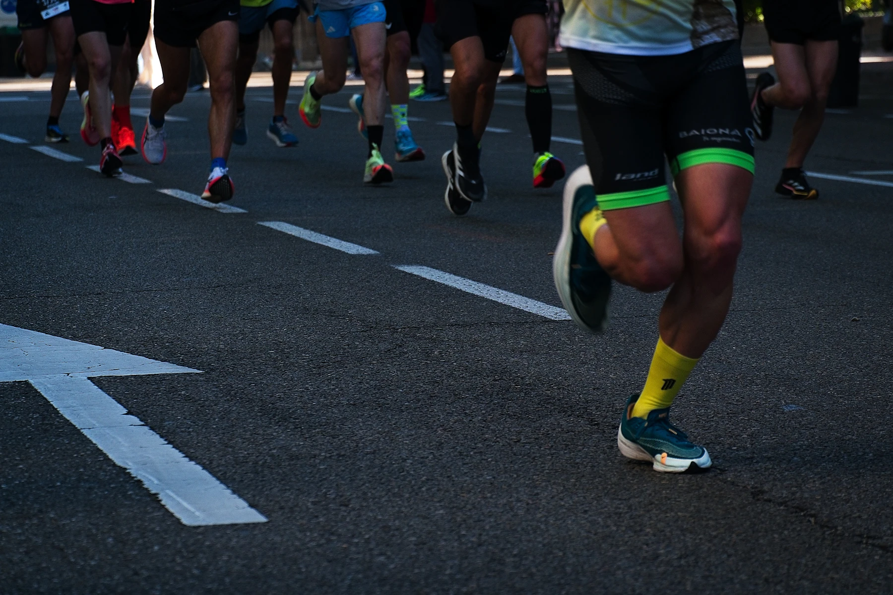 A group of runners moving through a city street