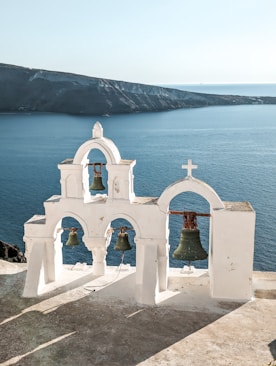 a bell tower with two bells on top of it