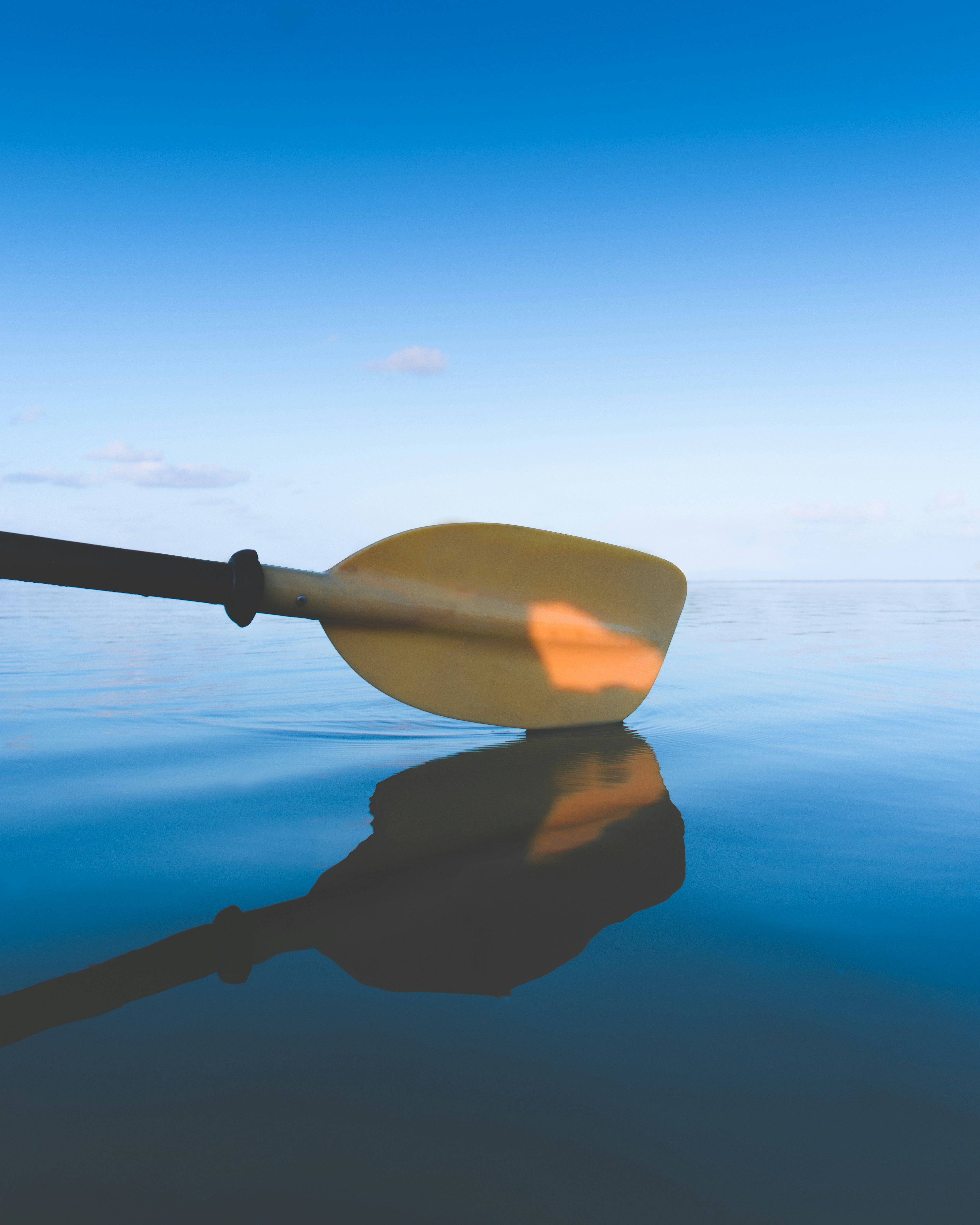 a single kayak floating on top of a body of water
