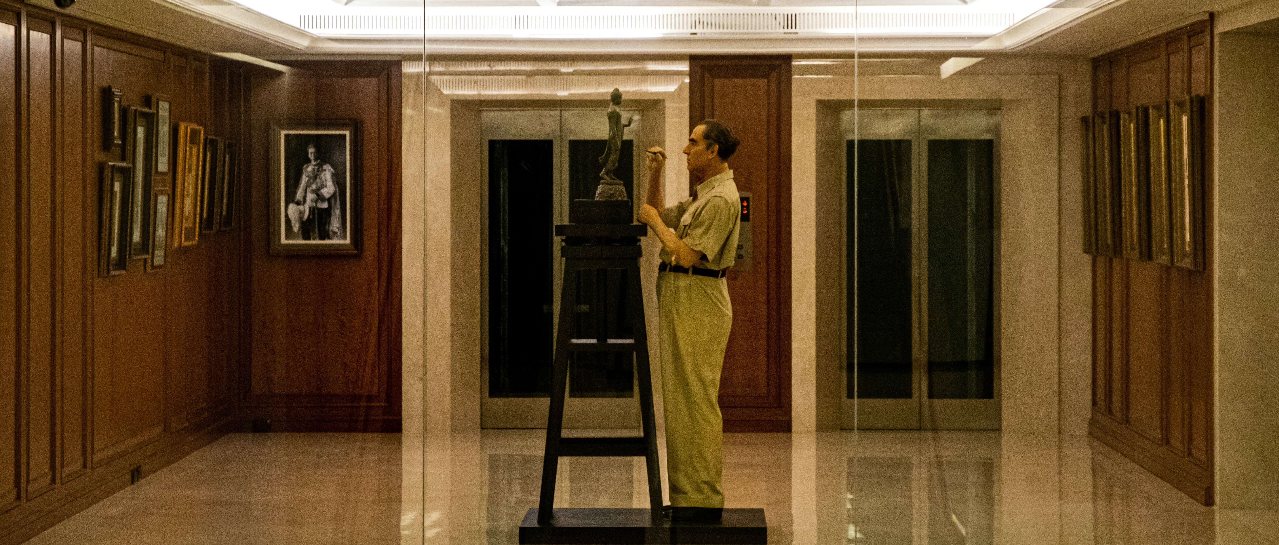 a woman standing in a room with a clock