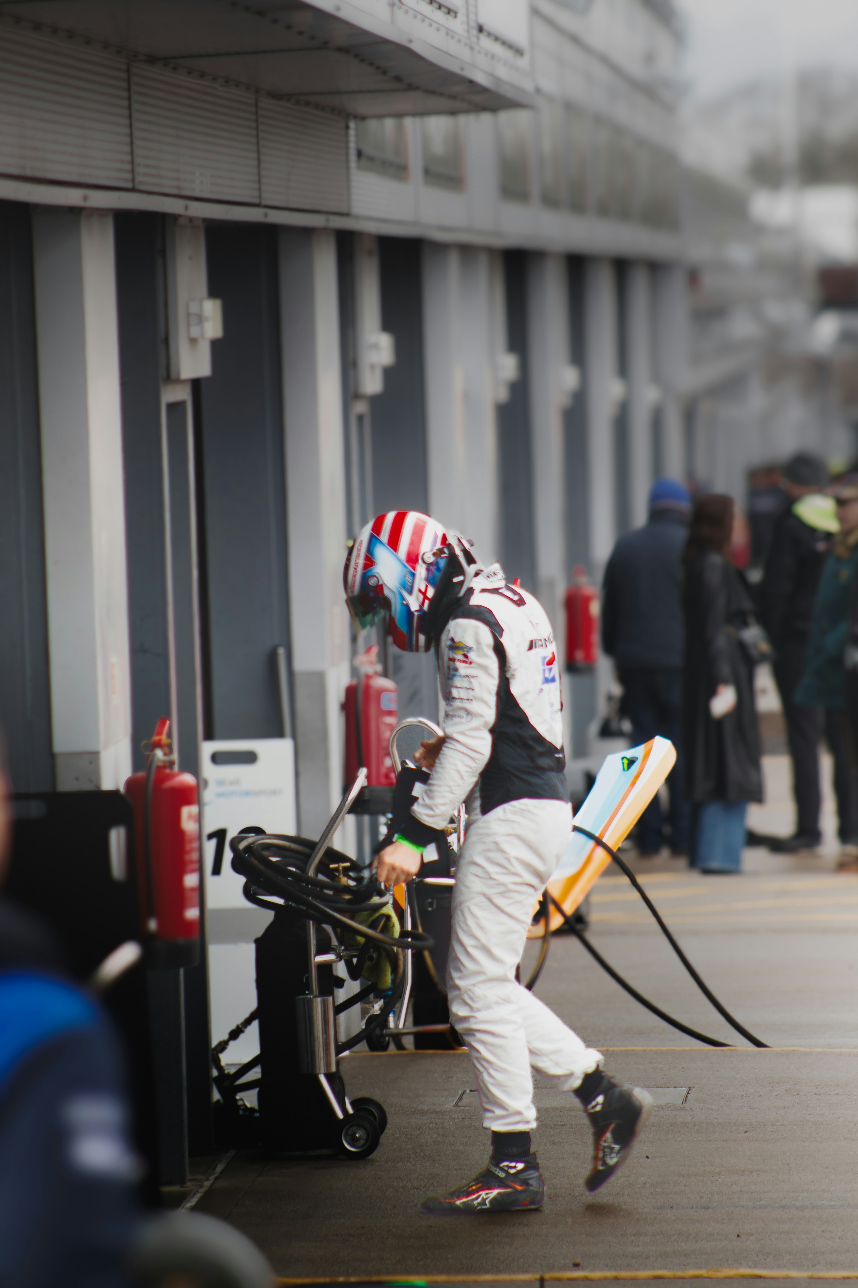 a man with a helmet and goggles is pulling a luggage cart