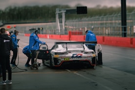 a car is being worked on on a race track