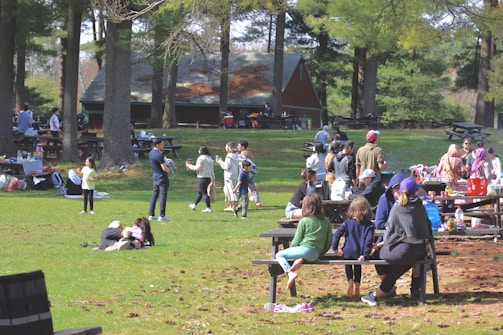 a group of people sitting on top of a park bench
