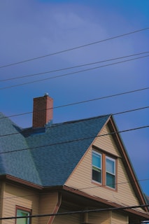 a house with a blue roof and a chimney