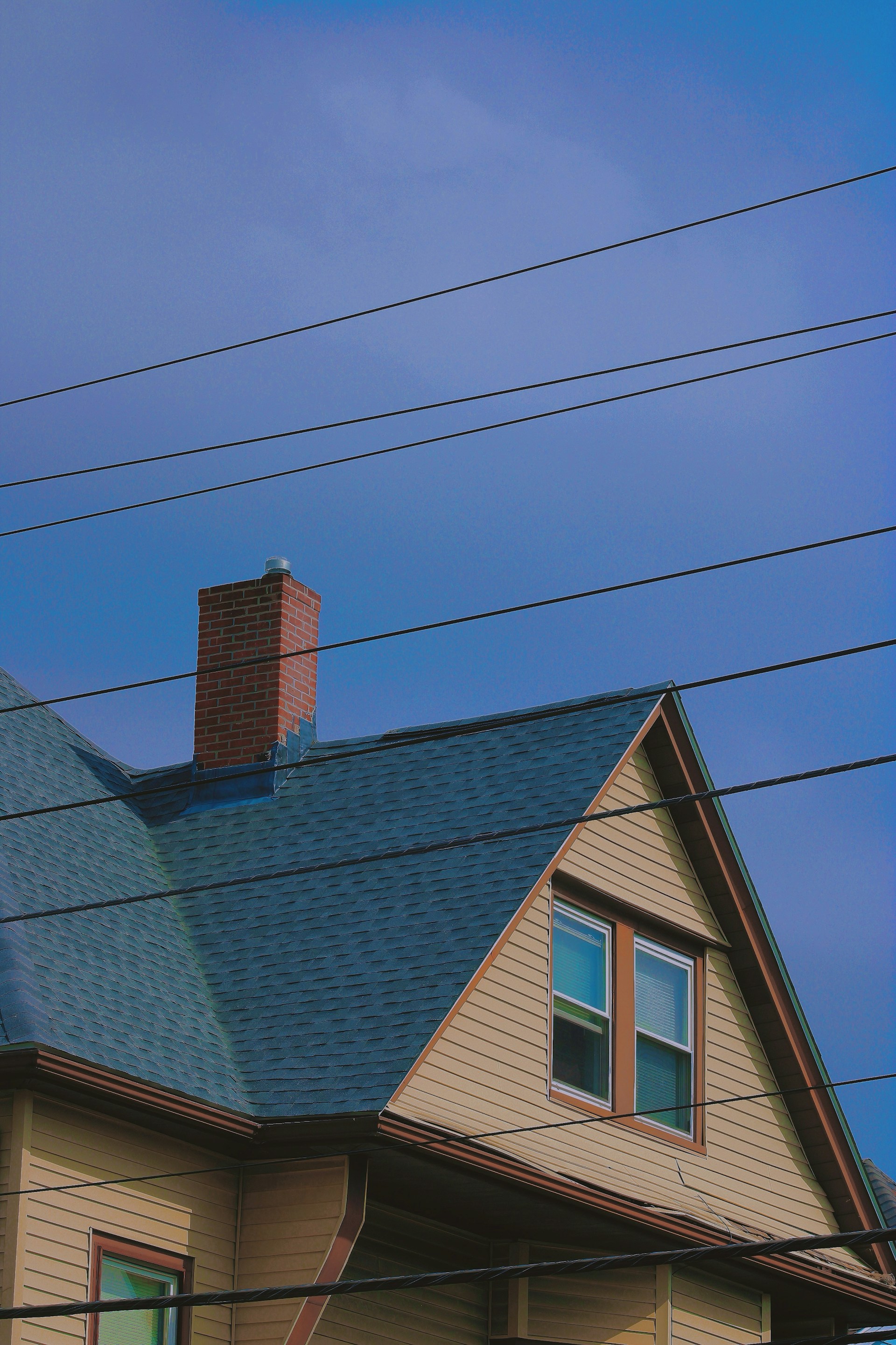 a house with a blue roof and a chimney