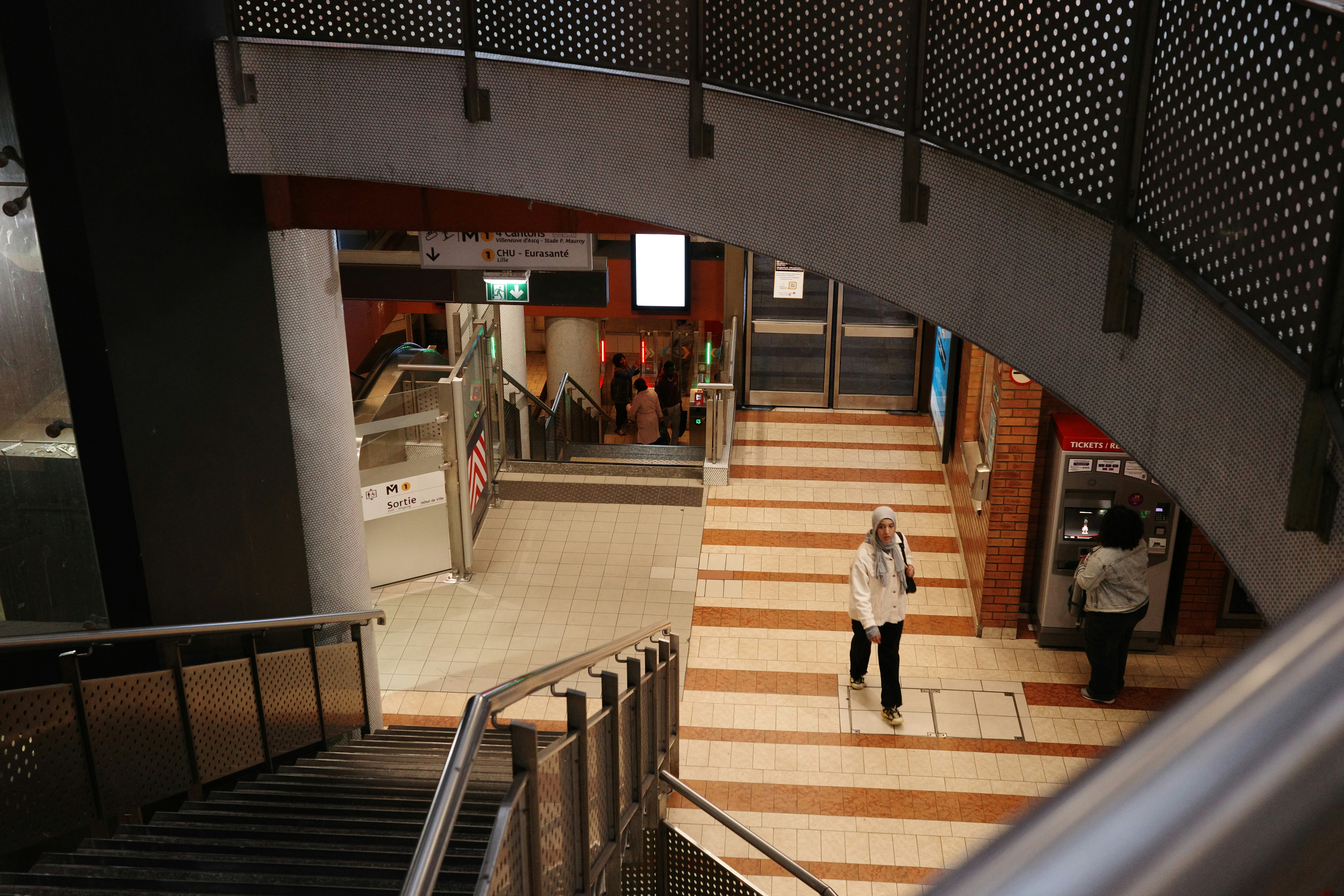 a woman is walking down a set of stairs