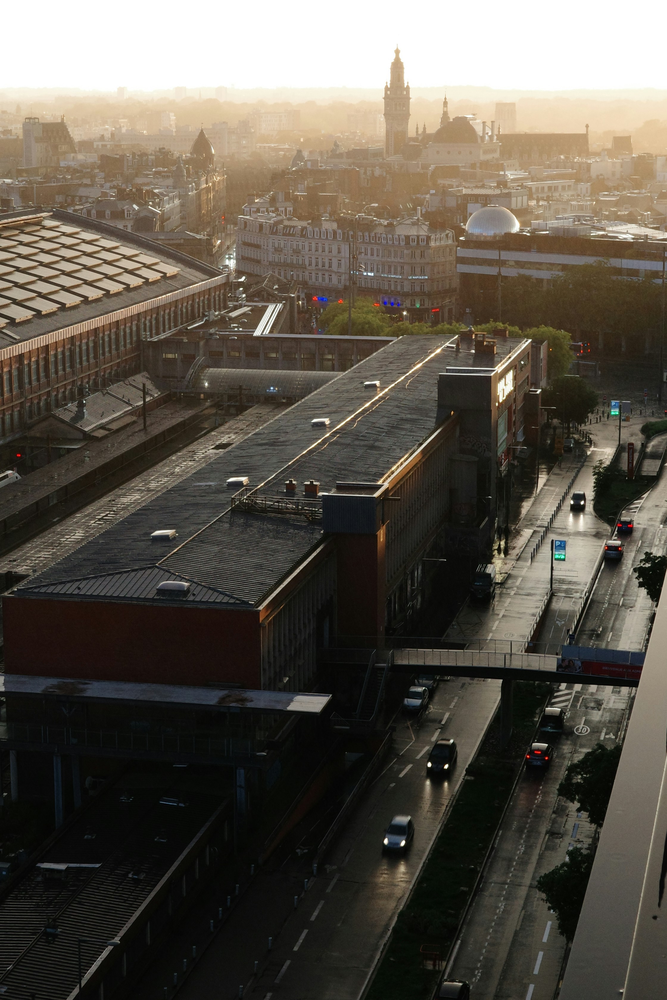 an aerial view of a city street with a train on the tracks
