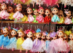 a bunch of dolls that are on a shelf