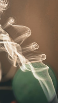 a blurry photo of a green object with smoke coming out of it
