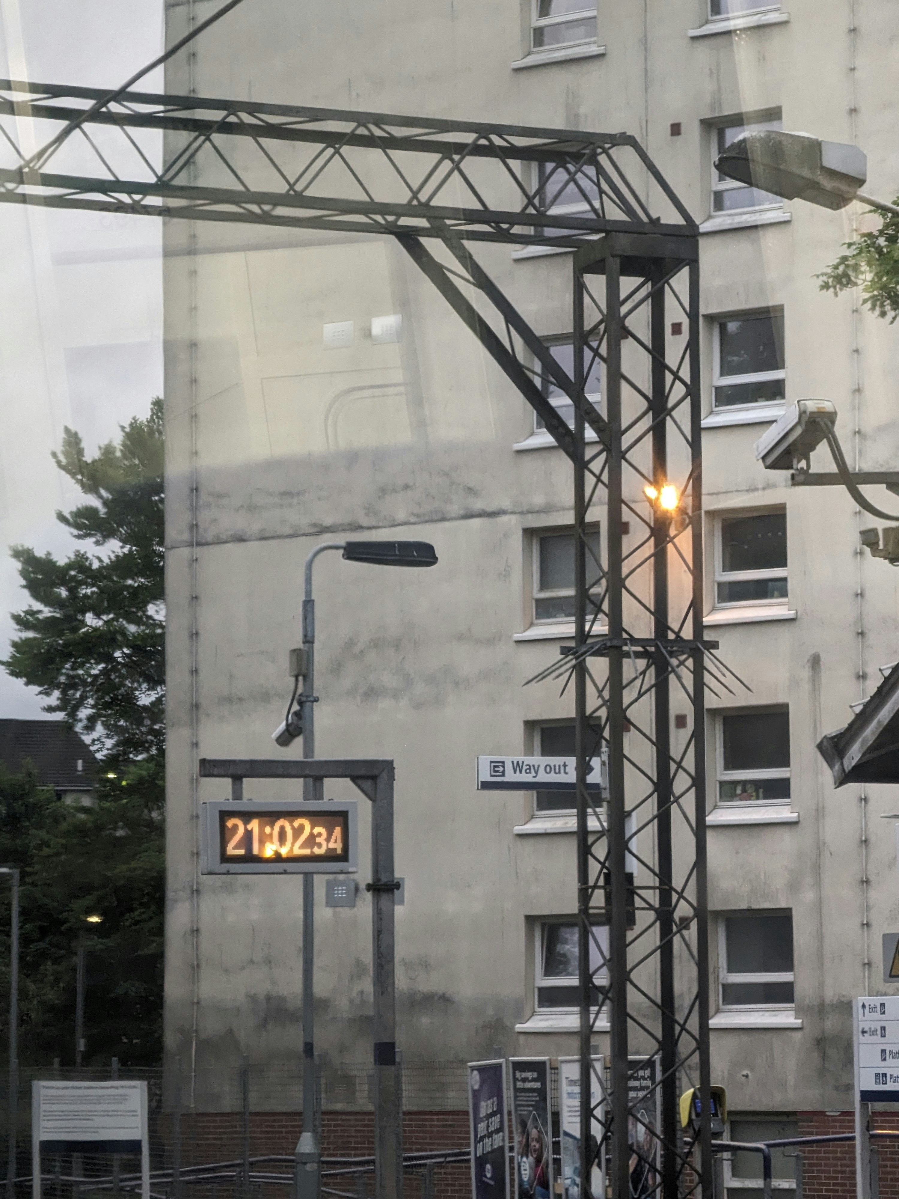 a street light sitting next to a tall building