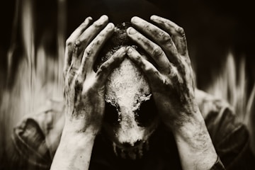a person covering their face with their hands
