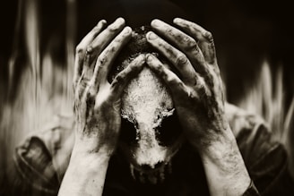 a person covering their face with their hands