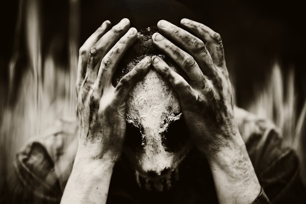 a person covering their face with their hands