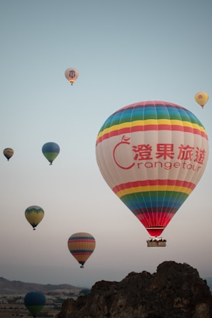 a group of hot air balloons flying in the sky