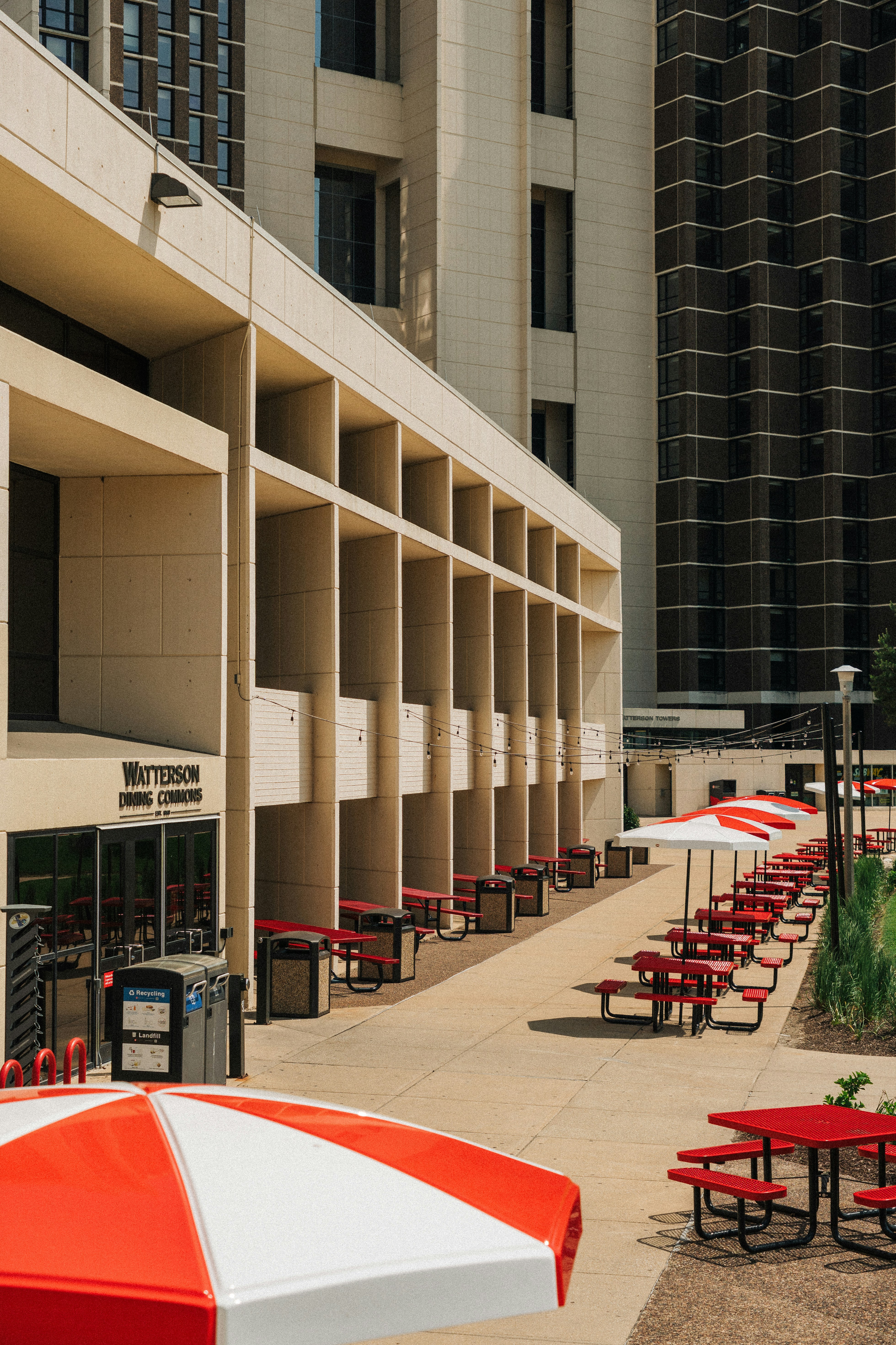 A row of red and white umbrellas sitting in front of a building