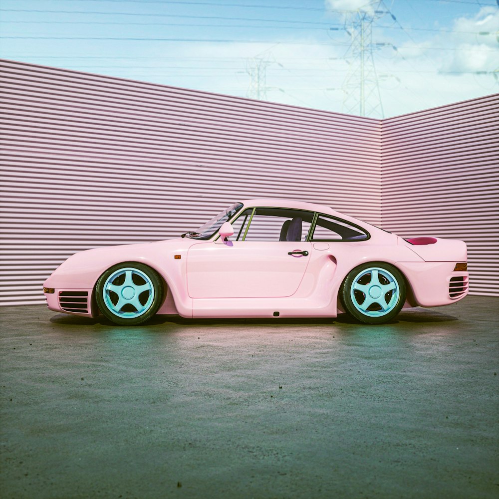 a pink car parked in front of a wall