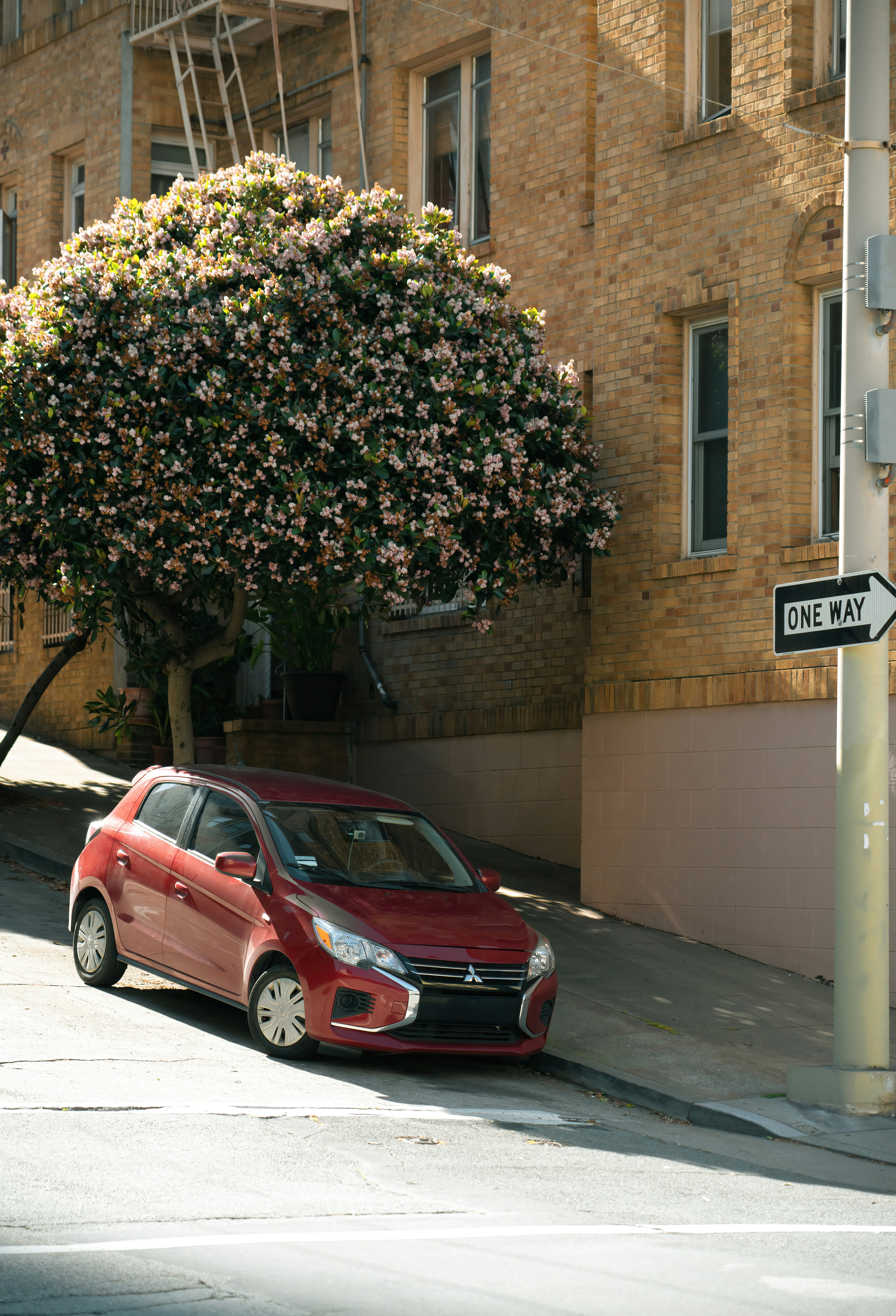 A red car parked on the side of the road photo – Free Building Image on ...